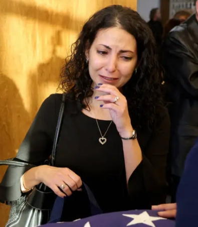   Gregorio's wife in a black dress