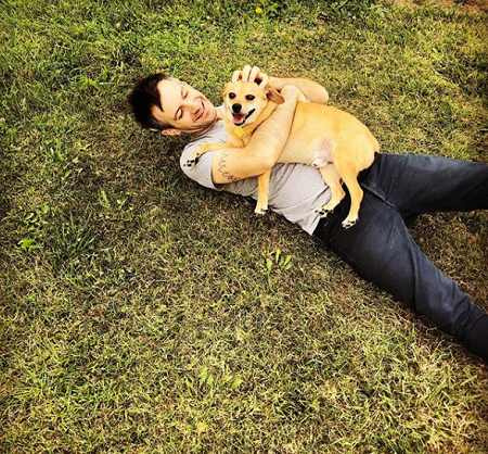   Mina Kimes' husband playing with her pooch Lenny