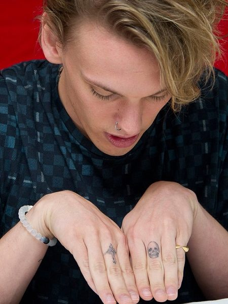Jamie Campbell también se ha tatuado una cruz en el dedo medio de su brazo derecho y una calavera en el dedo medio izquierdo.