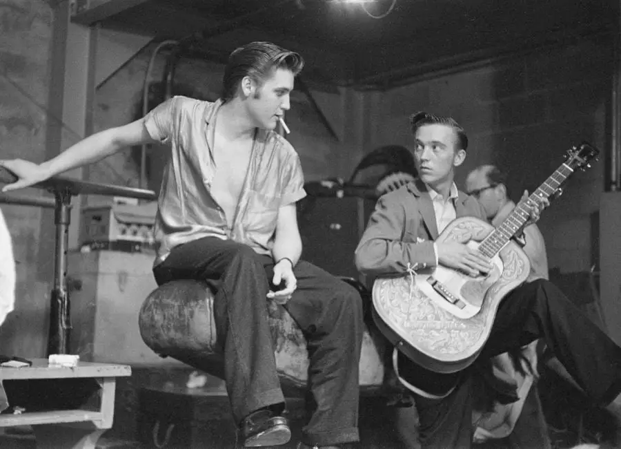 Elvis Presley, Scotty Moore, and Gene Smith backstage at the University of Dayton Fieldhouse, May 27, 1956