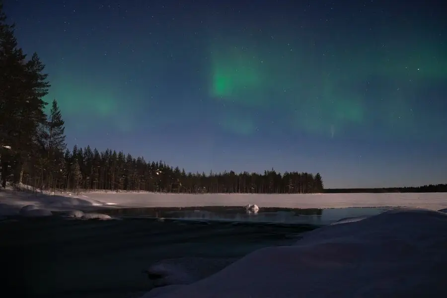 Northern lights in Finland by a lake