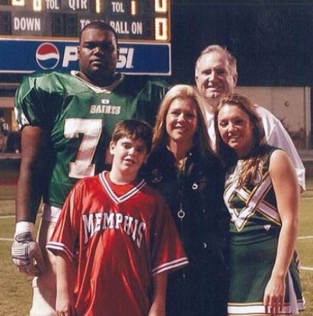 Carlos Oher's brother Michael with his adoptive parents